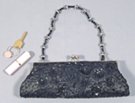 black satin mini short shoulder bag/clutch. sequined and beaded with retractable beaded strap. satin lined with key pocket. 47" silver-tone chain included.
