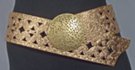 3" textured wide belt with rivets and cut-outs; 3.5" circular distressed metal buckle; rides low on hips with extra long overhang