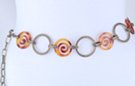 chain belt: alternating amber spirals and big cross-hatched antique gold rings, all joined by double stippled antique gold chain links which also form the extension chain tipped by a tiny gold ball
