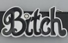 belt buckle with black lettered "Bitch" on white enamel