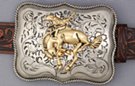nickel and brass bustin' bronco belt buckle, swirled field and rope edge