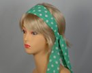 green headscarf with white polka dots attached to plastic headband