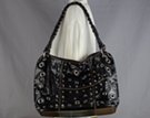 black eyelets and studs decorated tote with braided shoulder strap and tassel pull