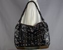 black eyelets and studs decorated tote with braided shoulder strap and tassel pull