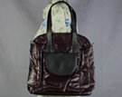 black, crinkly "flight-jacket" tote with contrasting half-moon outside pocket