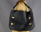 single-strap black duffle with rounded corners and vertically aligned big gold buttons
