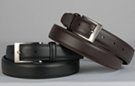 pair of medium narrow men's grain leather dress belt, chrome buckle and leather retainer