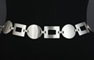 silver pebbled frame and shield chain belt