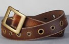distressed leather belt with single row of antique brass eyelets and center bar buckle