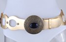 wide gold loops with studs, big bronze disk and black stone western-style buckle