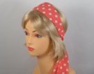 salmon pink headscarf with white polka dots attached to plastic headband
