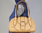 creamy tan small satchel shoulder bag with magnetic saddle flap and ornamental buckle
