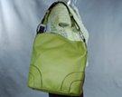 convex top day bag, semi-circles stitched at lower corners and big nickel polish rings at strap; little feet and adjustable shoulder strap