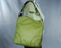 convex top day bag, semi-circles stitched at lower corners and big nickel polish rings at strap; little feet and adjustable shoulder strap