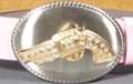 brushed chrome oval with rhinestone studded gold revolver