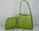 green shoulder purse with arching straps and matching clutch