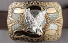 belt buckle, silver eagle over gold Aztec sunburst
